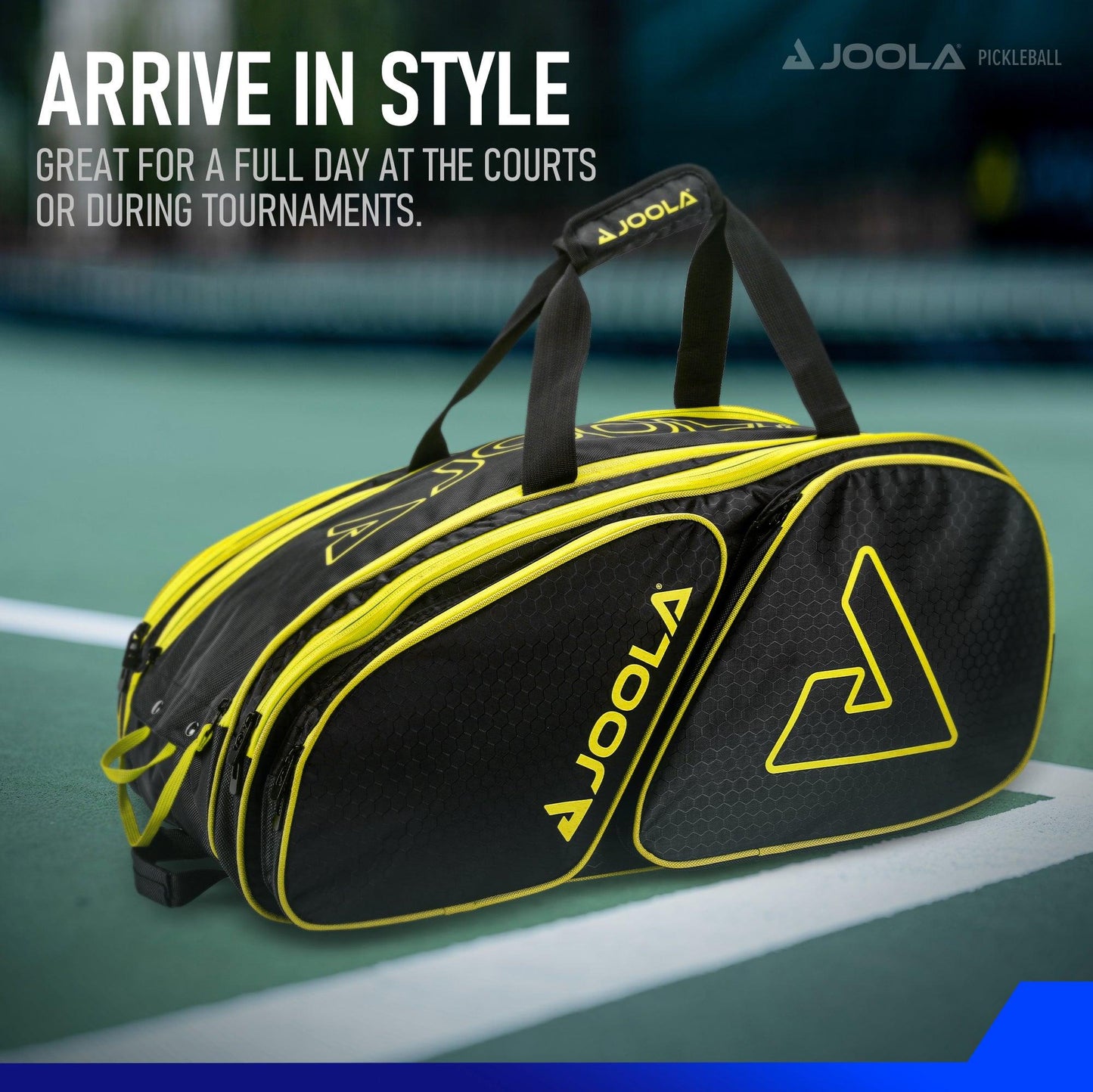 A versatile JOOLA Tour Elite Pickleball Bag with yellow accents and the Pickleball Zone logo is placed on a tennis court. The text reads "Arrive in style. Great for a full day at the courts or during tournaments." The background shows part of a net and blurred court lines.