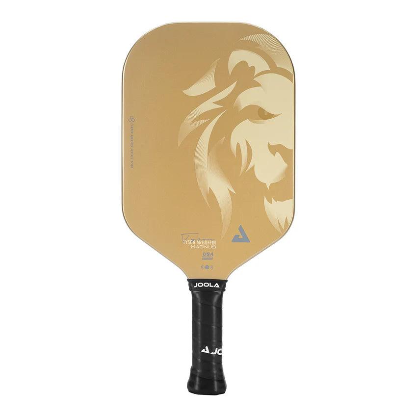 A gold Pickleball Zone TYSON MCGUFFIN MAGNUS CAS 14MM pickleball paddle showcasing an abstract lion head design on the surface. The handle is black and features the JOOLA brand name in white letters at the base, a style favored by champion Tyson McGuffin.