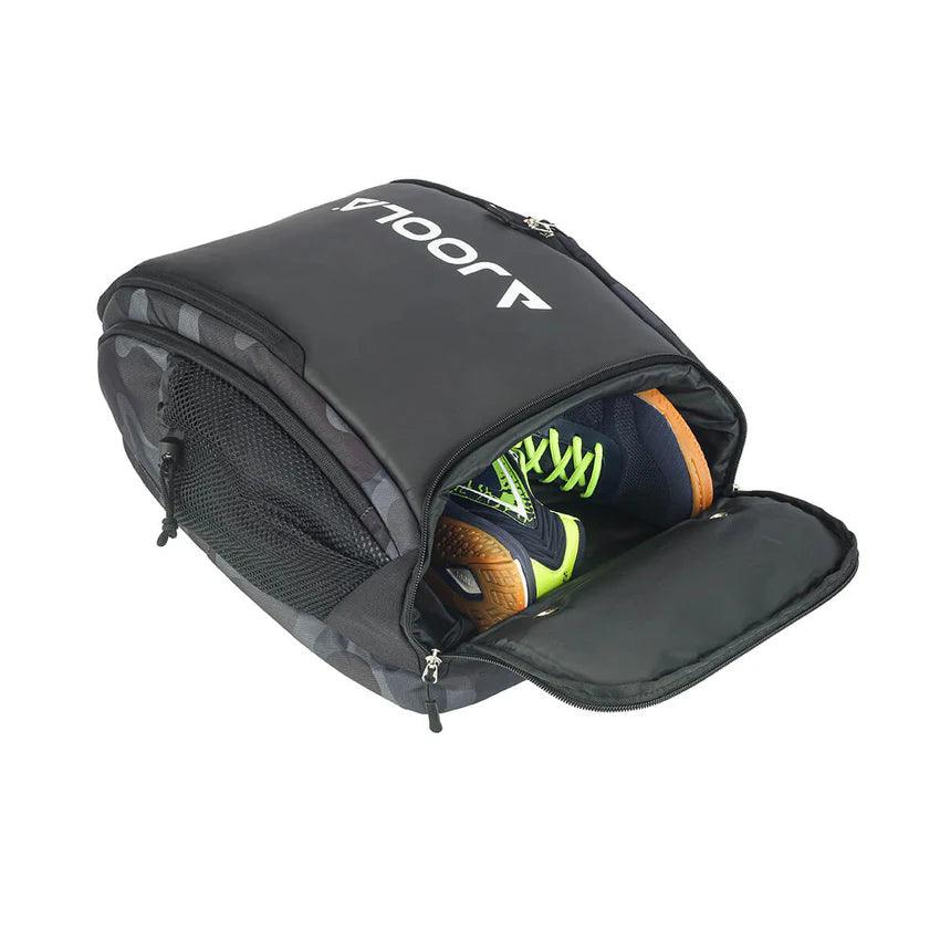 A black Pickleball Zone JOOLA Vision II Deluxe Pickleball Backpack with a compartment opened, revealing a pair of black and neon green athletic shoes inside. This ultimate storage solution features a top zippered flap, mesh side pockets, and displays the brand name "Pickleball Zone" in white lettering on the flap—perfect for on-the-go players.